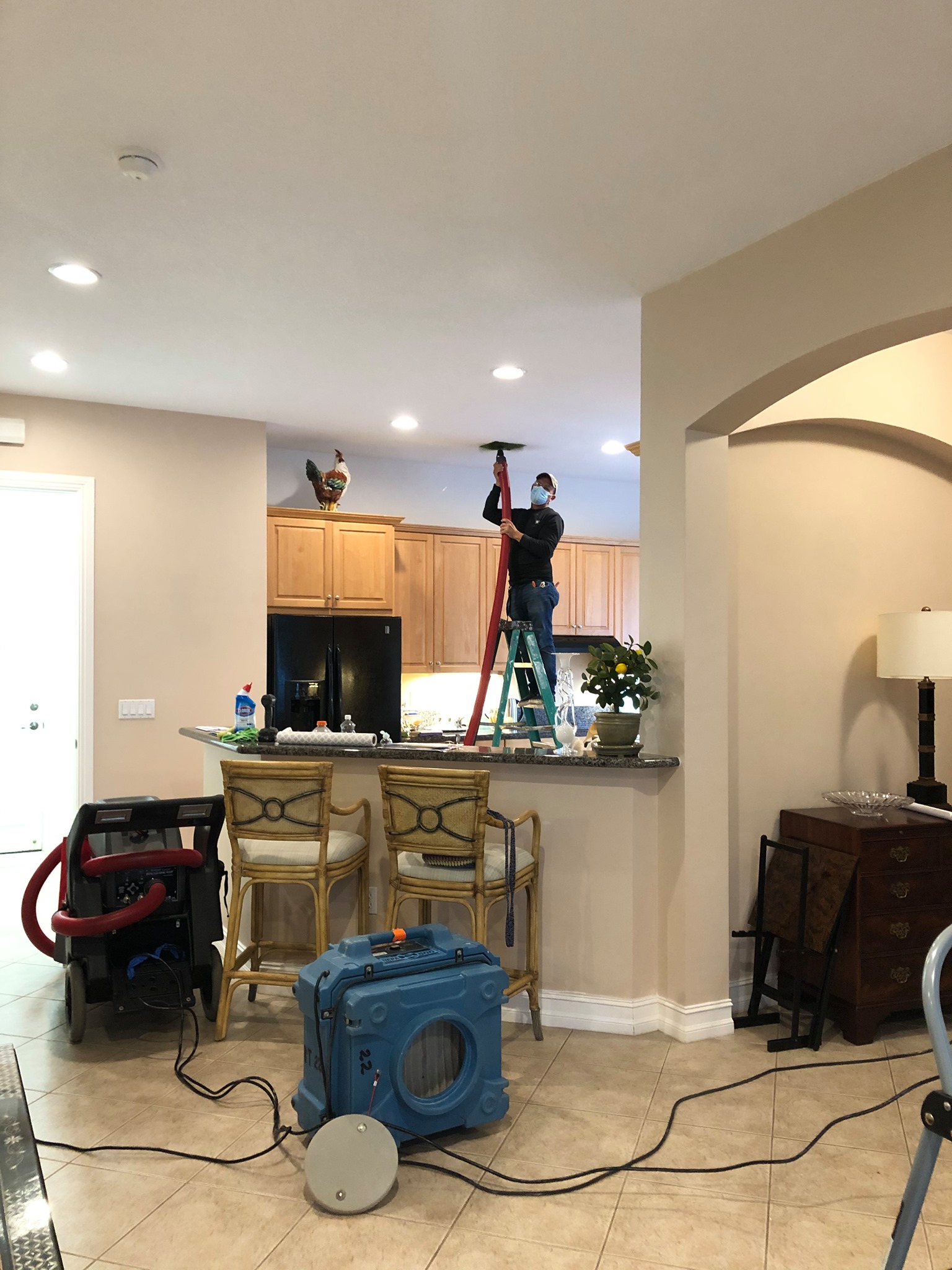 HVAC Services Near Me, Mold Cleanup in Palm Beach Gardens - FL in progress as a technician removes damaged drywall near a window