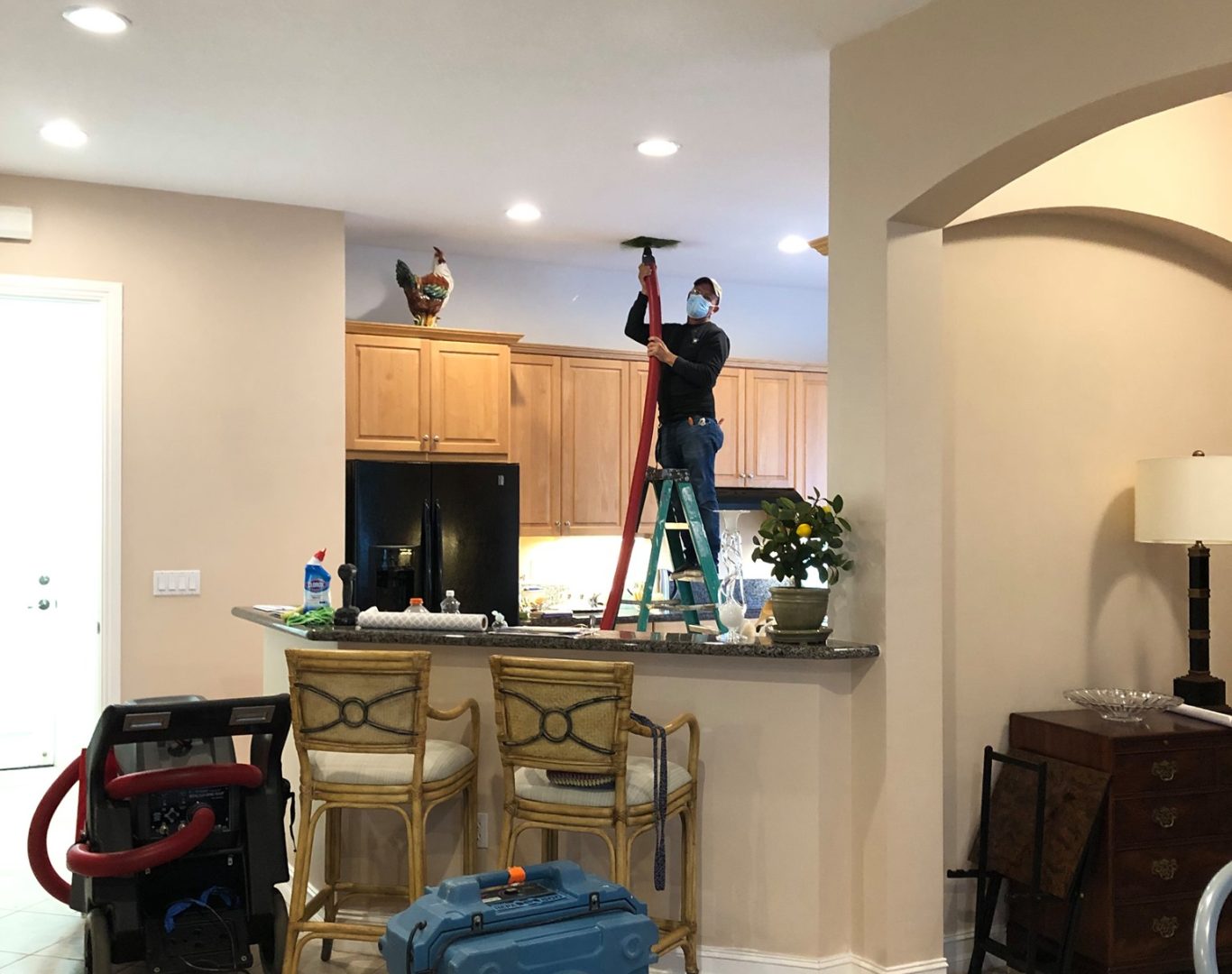 HVAC Services Near Me, Mold Cleanup in Palm Beach Gardens - FL in progress as a technician removes damaged drywall near a window